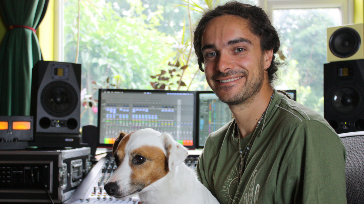 Ralph Stokes in his music production studio with is dog